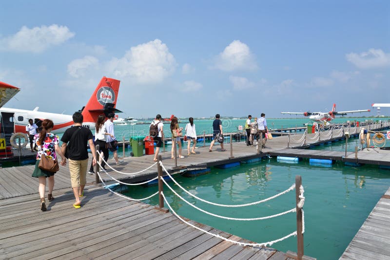 Male, Maldives - February 1, 2016: Passengers are boarding seaplane at Male, Maldives. Male, Maldives - February 1, 2016: Passengers are boarding seaplane at Male, Maldives