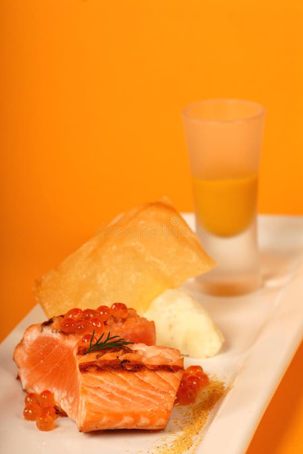 Seared salmon with caviar and pumpkin soup