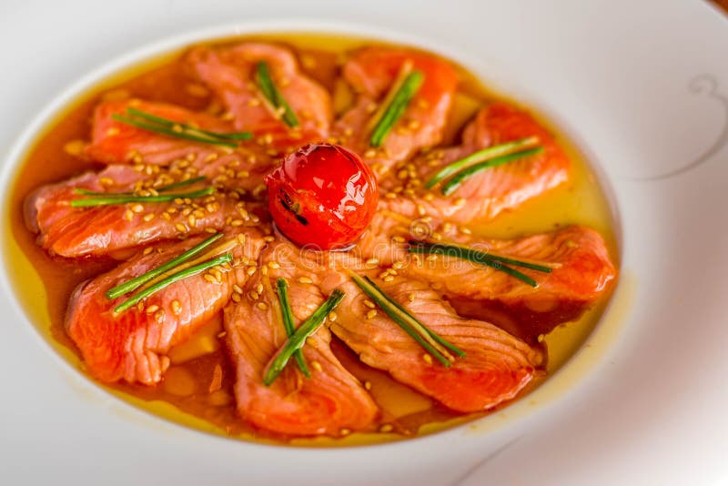 Seared Salmon Karashi Sumiso with Tomato on a White Plate Stock Photo