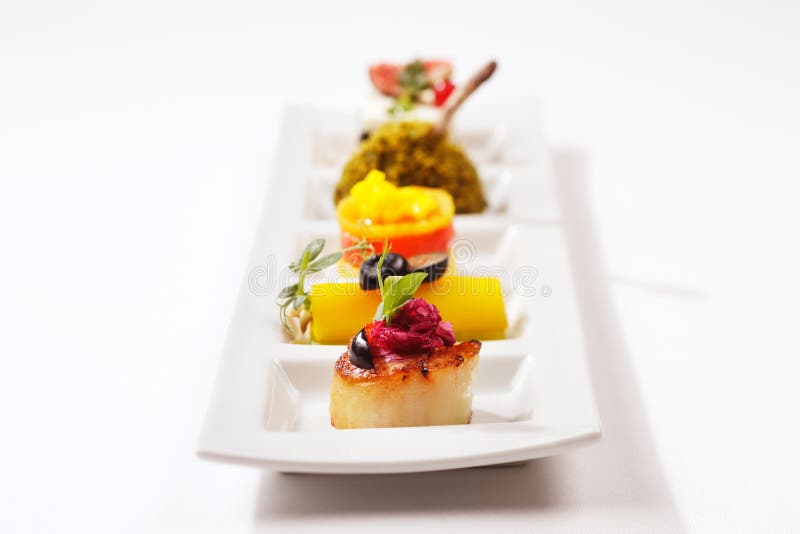 Seared scallop, tuna wrap and smoked salmon royalty free stock photos