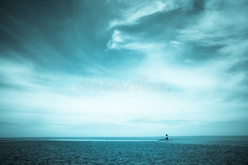 Seascape and dramatic clouds with Orient Point Lighthouse, Long Island, New York in the distance. Seascape and dramatic clouds with Orient Point Lighthouse, Long Island, New York in the distance