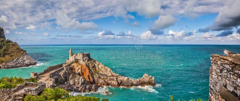 Panoramic view of the famous gothic Church of St. Peter (Chiesa di San Pietro) with seagull on a rock in the town of Porto Venere, Ligurian Coast, province of La Spezia, Italy. Panoramic view of the famous gothic Church of St. Peter (Chiesa di San Pietro) with seagull on a rock in the town of Porto Venere, Ligurian Coast, province of La Spezia, Italy.