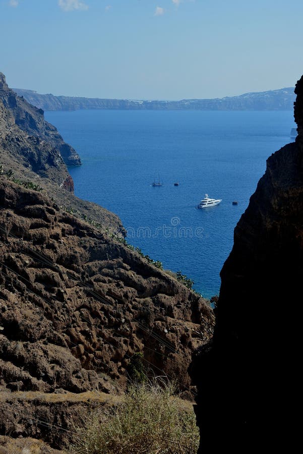 seascape through a wild landscape and a yacht anchored in front of Santorini royalty free stock image seascape through a wild landscape and a yacht anchored in front of Santorini royalty free stock image