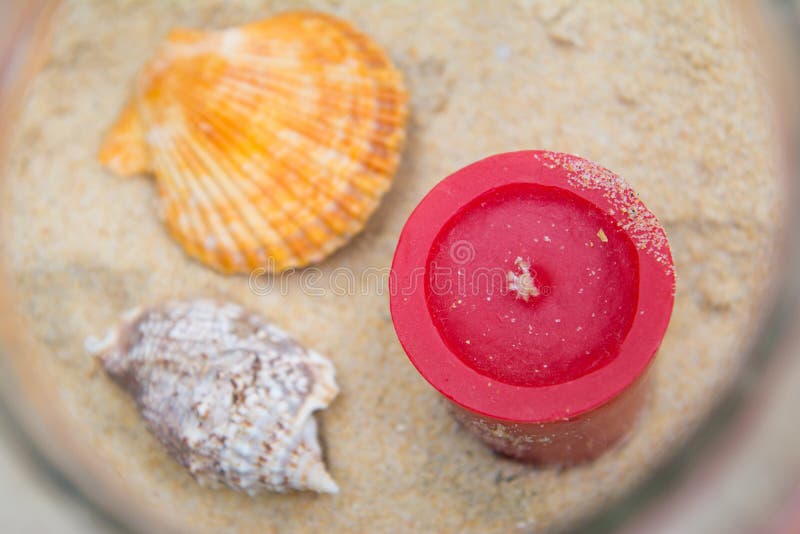 Seashells and candles decorated in jar royalty free stock images