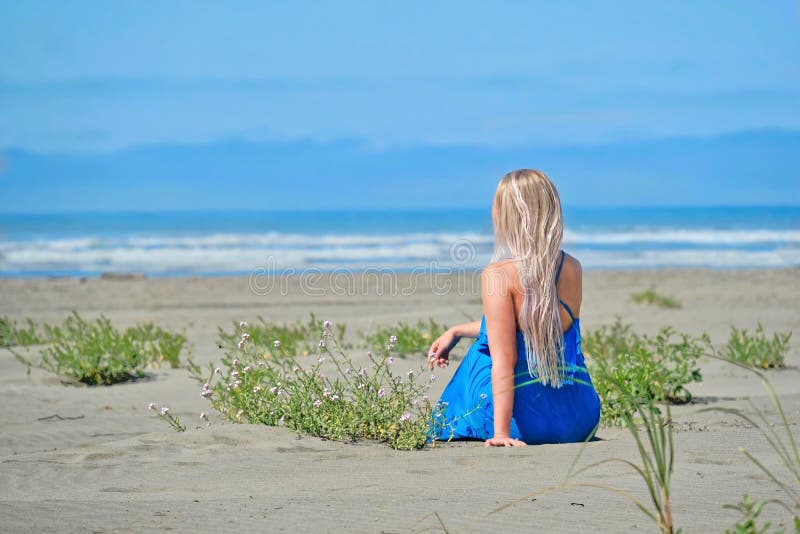 Summer vacation on beach. Woman on beach looking at the sea. stock photo Summer vacation on beach. Woman on beach looking at the sea. stock photo