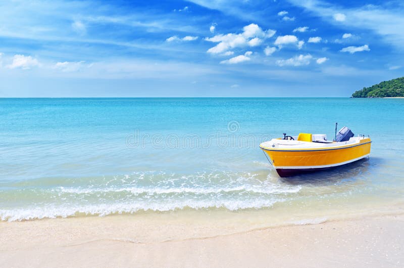 Yellow boat on a beach stock image