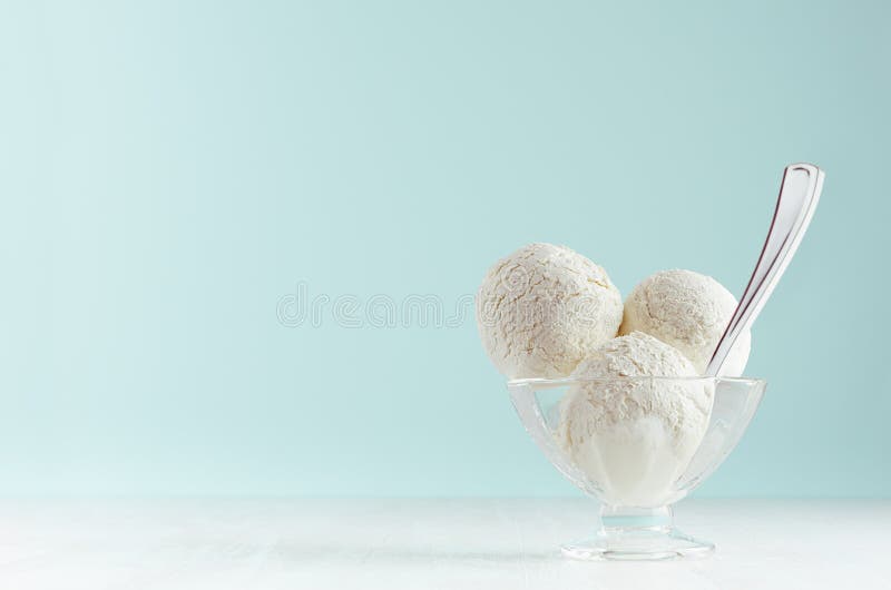 Seasonal sweet dairy dessert - creamy ice cream scoops in elegant bowl with silver spoon in modern stylish pastel green color. royalty free stock images Seasonal sweet dairy dessert - creamy ice cream scoops in elegant bowl with silver spoon in modern stylish pastel green color. royalty free stock images