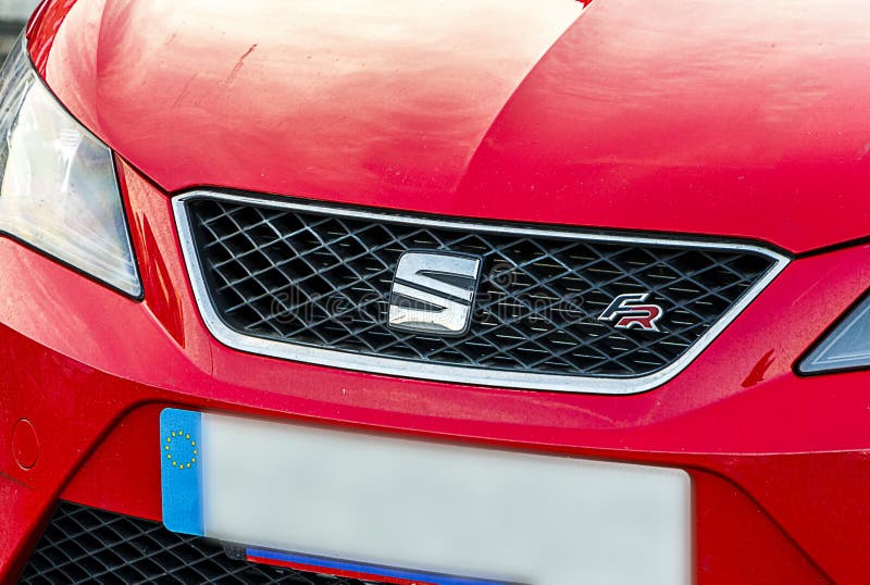 Seat logo on front of red car.