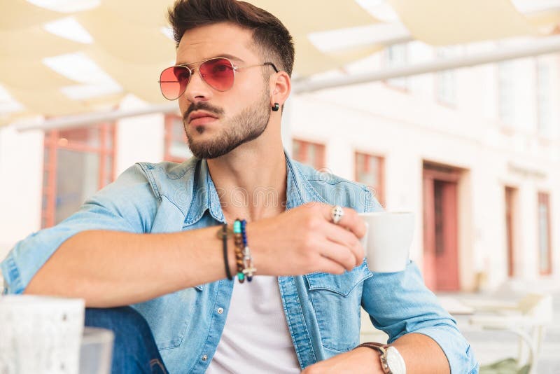 Seated Casual Man Drinking Coffee in City Looks To Side Stock Photo ...