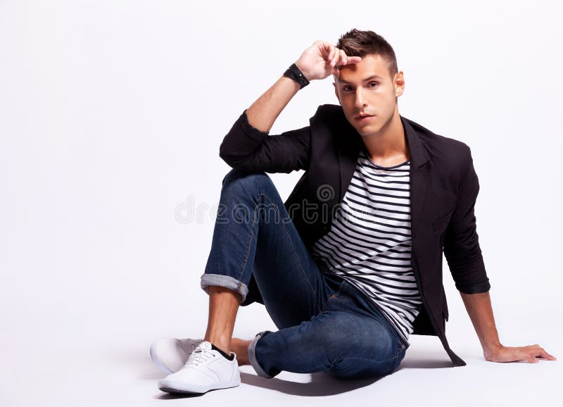 A handsome male model posing at a studio in front of a black background  Stock Photo - Alamy