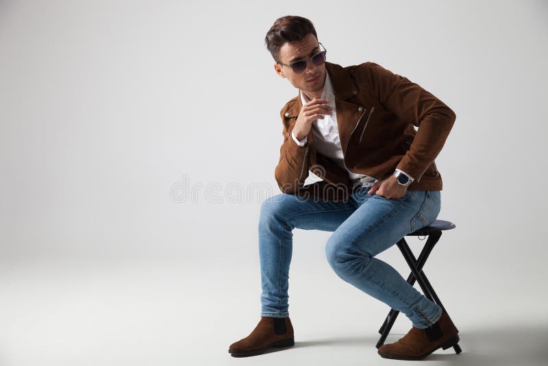 Seated Young Fashion Man Looks Back Over His Shoulder Stock Image ...