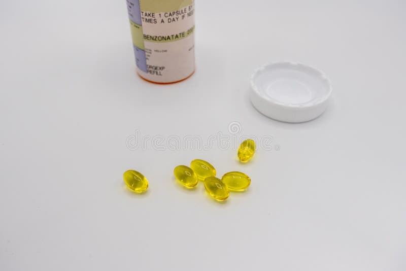 Selective focus on benzonatate pills on a white background. Selective focus on benzonatate pills on a white background