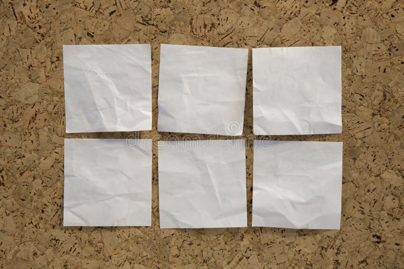 Six blank crumpled white sticky notes on a cork bulletin board. Six blank crumpled white sticky notes on a cork bulletin board