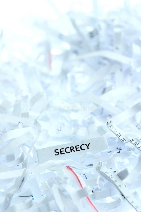 Secrecy written on shredded paper