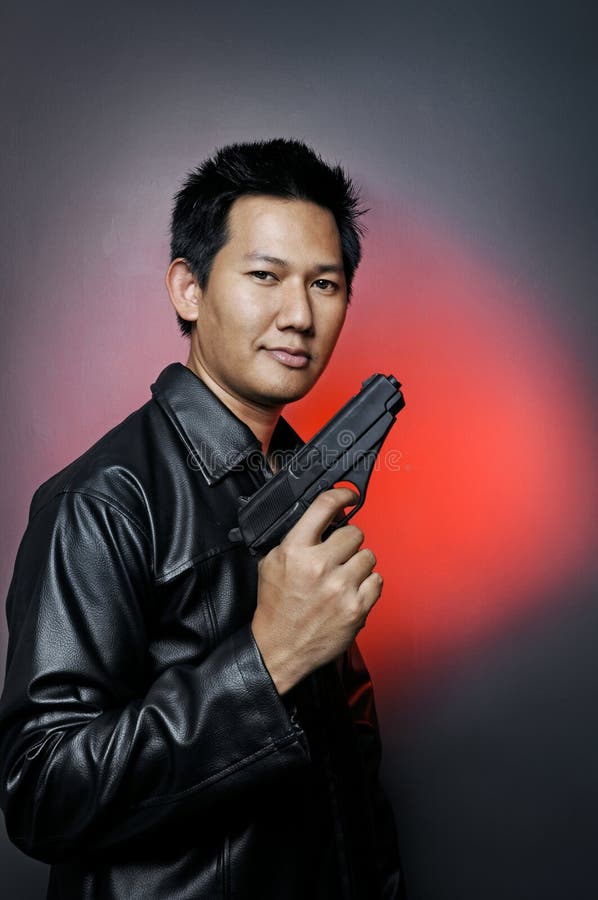 Male posing with semi automatic pistol. Male posing with semi automatic pistol