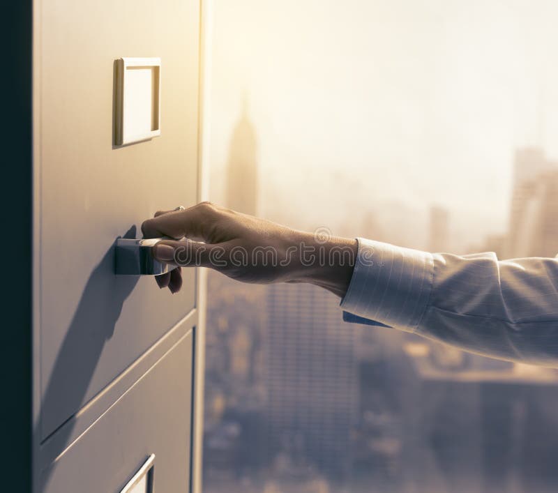 Secretary Searching Files In The Filing Cabinet Stock Photo