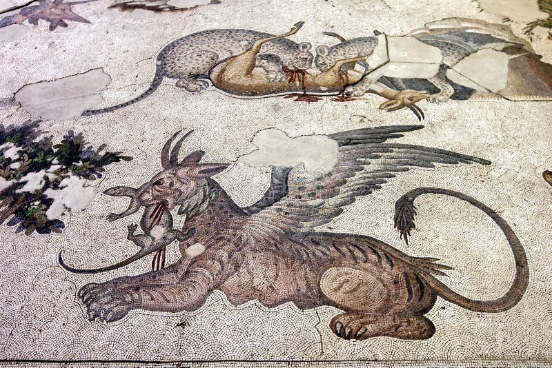 A section of Byzantine 5th century mosaics from the Great Palace Mosaic at the Istanbul Mosaic Museum in Istanbul in Turkey. This scene features a griffin lion in the foreground and two leopards devouring a deer in the background.