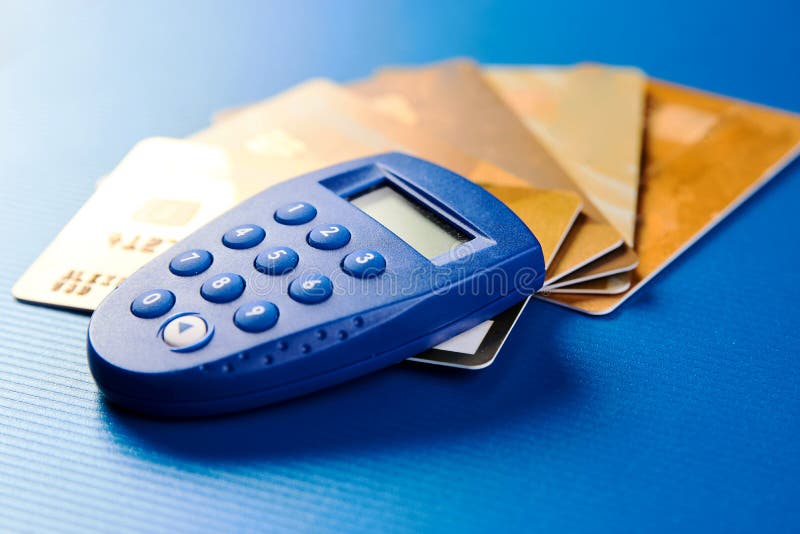 Secure wireless payment concept. Gold credit cards and security remote stock images Secure wireless payment concept. Gold credit cards and security remote stock images