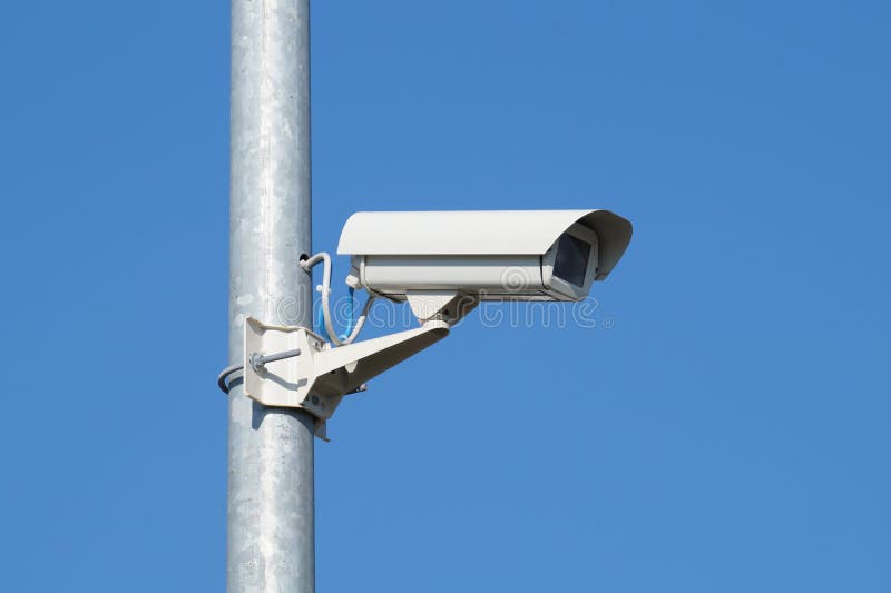 Security camera and urban video at pole blue sky royalty free stock images