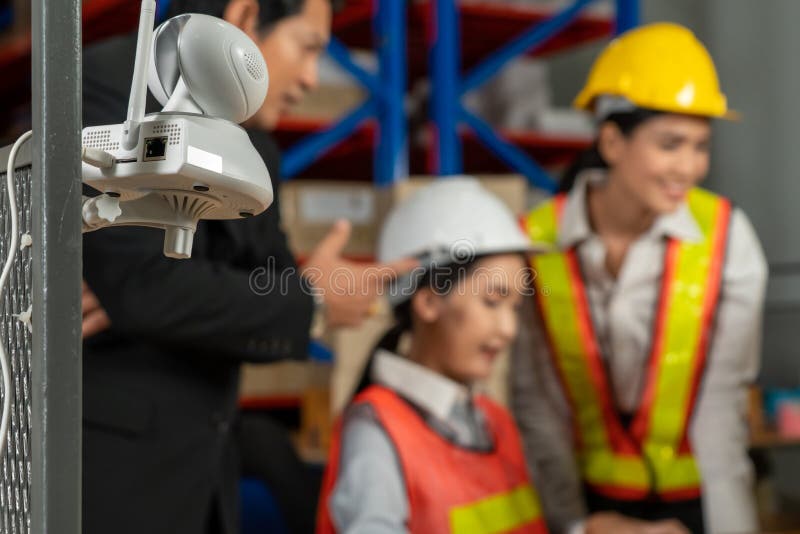 Security Camera Watching Warehouse Workers Working in the Storehouse