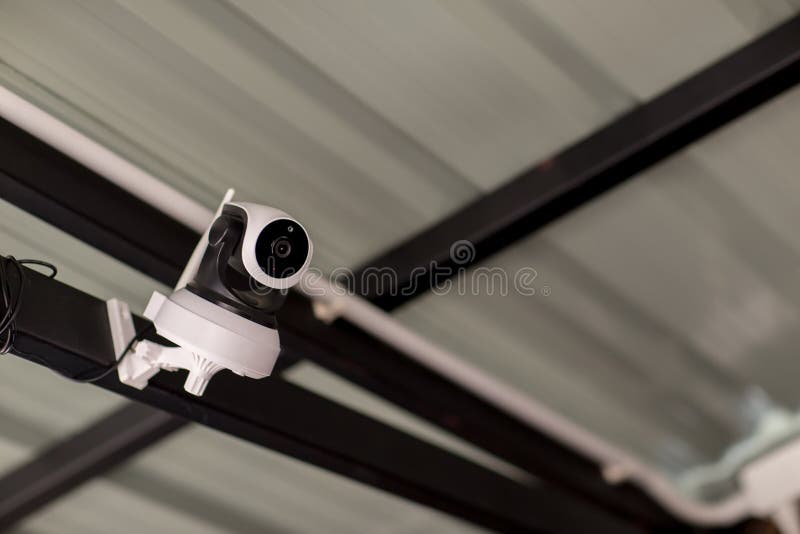 Security CCTV camera surveillance system outdoor of house. A blurred night city scape background. Modern CCTV camera on a wall. stock image Security CCTV camera surveillance system outdoor of house. A blurred night city scape background. Modern CCTV camera on a wall. stock image