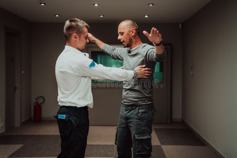 Security Guard Making Body Searching Procedure on Man for Finding