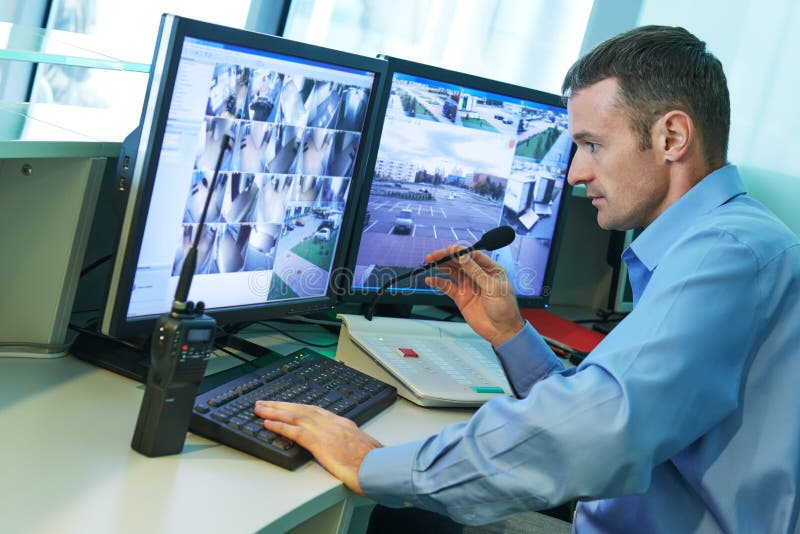 Security worker during monitoring. Video surveillance system.