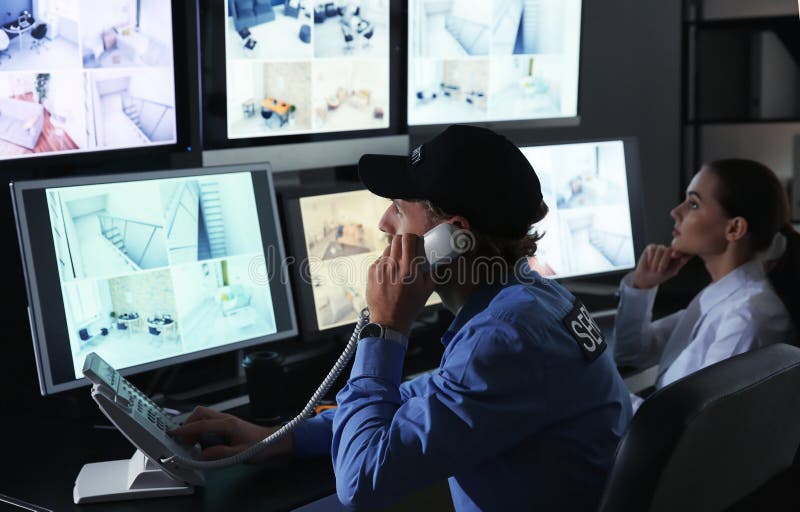 Security guards monitoring modern CCTV cameras in surveillance room royalty free stock photography Security guards monitoring modern CCTV cameras in surveillance room royalty free stock photography