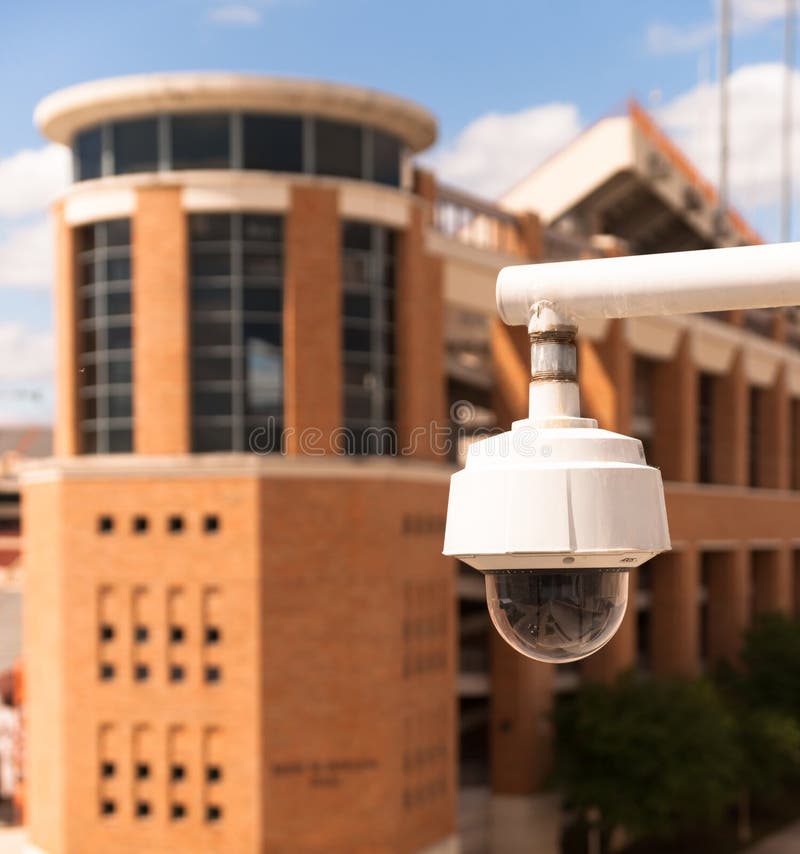 Video Security Camera Housing Mounted High on College Campus Stock