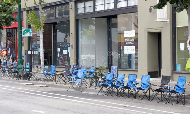 Alameda, CA - July 4, 2023: Alameda 4th of July Parade, one of the largest and longest Independence Day parade in the nation. Spectator chairs set up hours before the small town event starts. Alameda, CA - July 4, 2023: Alameda 4th of July Parade, one of the largest and longest Independence Day parade in the nation. Spectator chairs set up hours before the small town event starts