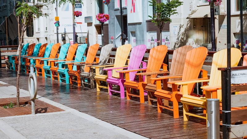 Colorful chairs on King street in front of International Film Festival building. Toronto, Canada - July 4, 2022. Colorful chairs on King street in front of International Film Festival building. Toronto, Canada - July 4, 2022.