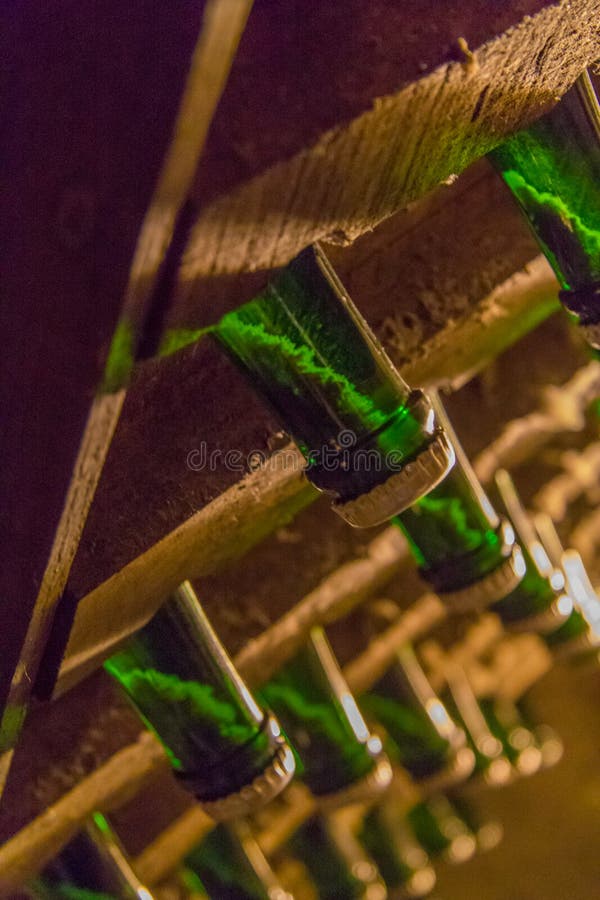 Sediment in champagne bottle. Close up view of the sediment settling in the neck of champagne bottles in racks stock photography