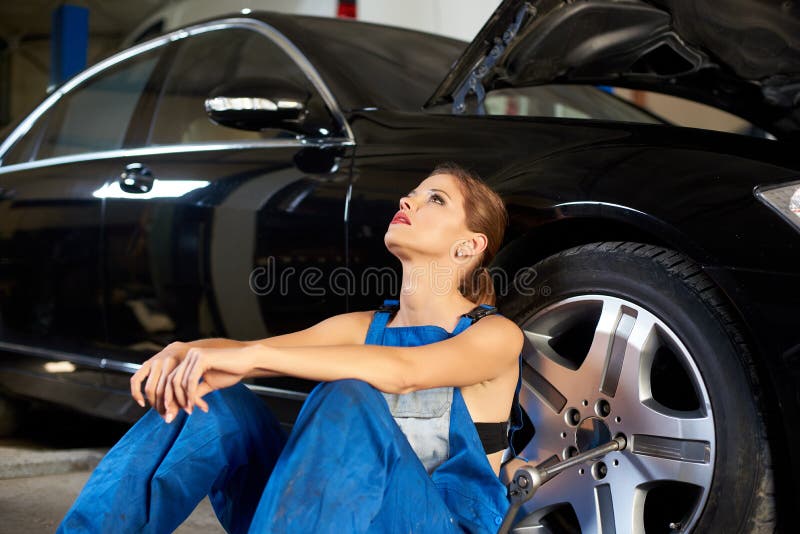Seductive Girl Near A Black Car In Repair Garage Stock Image Image Of