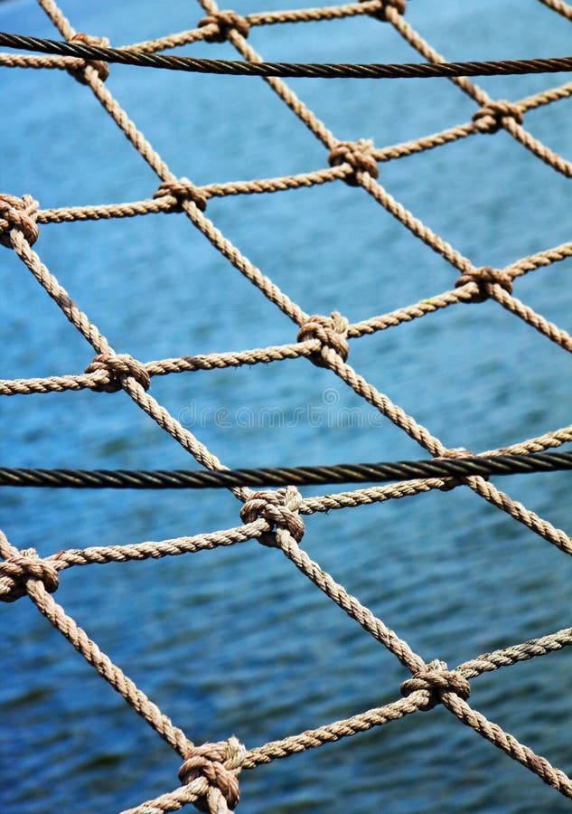 View through the safety net at the blue sea background. View through the safety net at the blue sea background