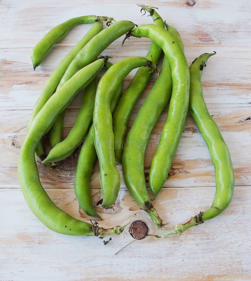 Ecological seedcases lima beans in a wooden table. Ecological seedcases lima beans in a wooden table.