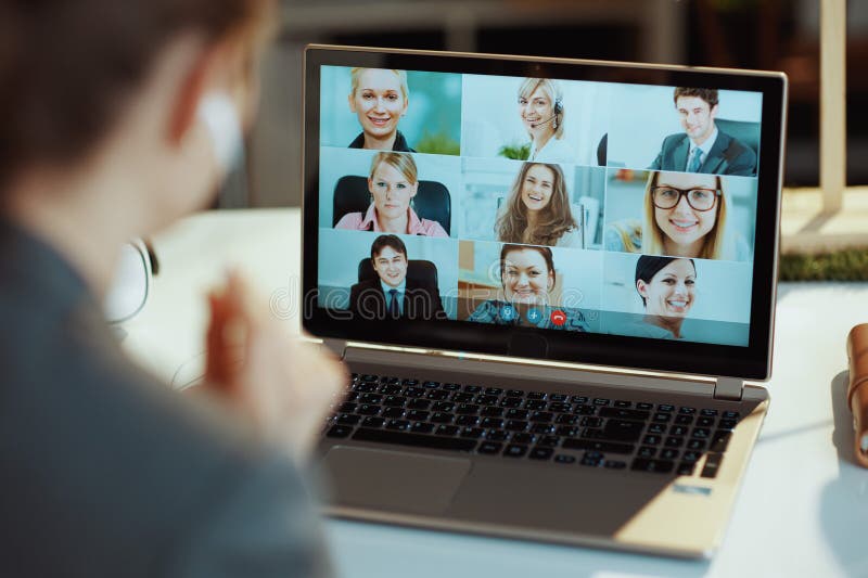 Seen from behind woman with laptop video chatting stock image