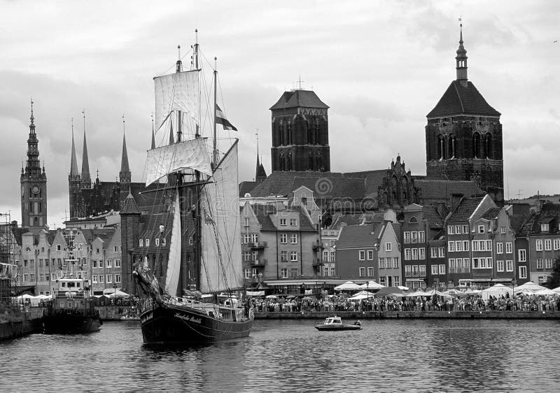 Dutch sailing ship in Gdansk old harbour, Poland. The vessel is from ca. 1930, the town in the background is medieval with tower on St.Marys church in the middle - the biggest brickstone church in the world. Dutch sailing ship in Gdansk old harbour, Poland. The vessel is from ca. 1930, the town in the background is medieval with tower on St.Marys church in the middle - the biggest brickstone church in the world.