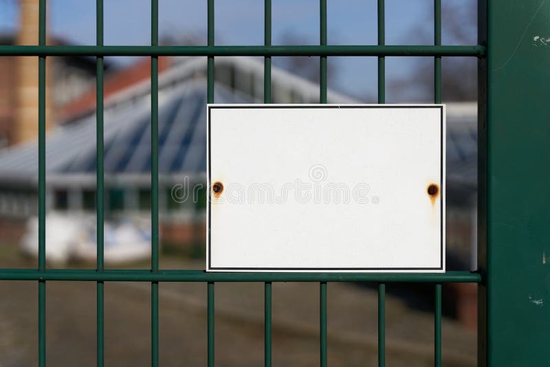 White unmarked sign on a fence with space for text. White unmarked sign on a fence with space for text