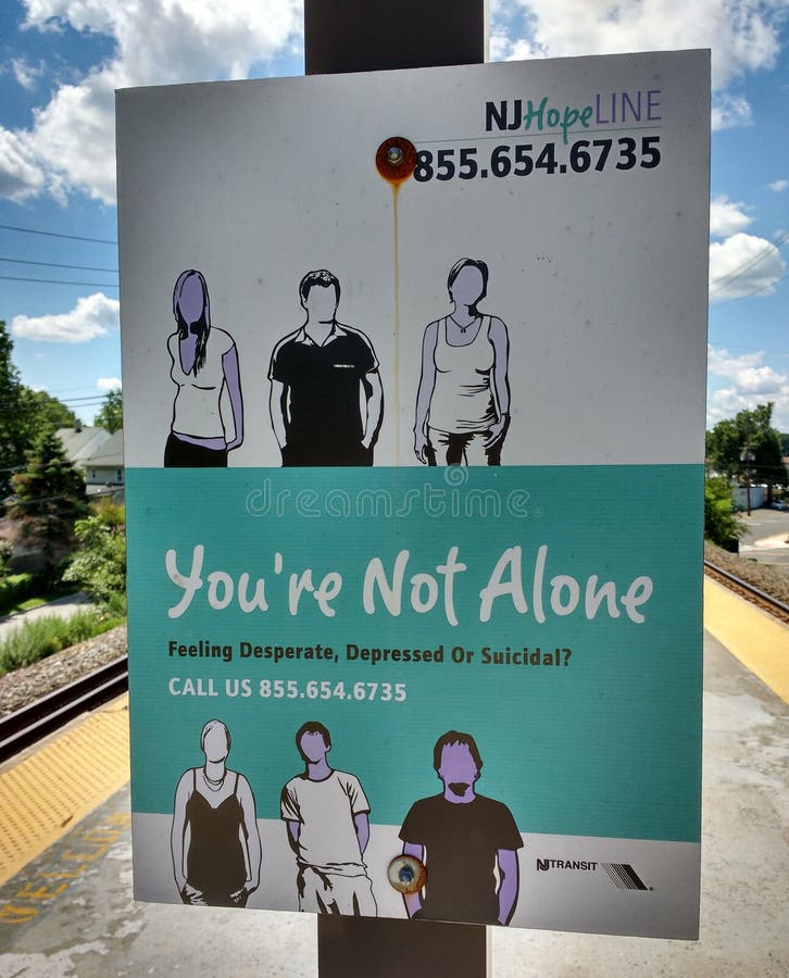 You're Not Alone: Feeling Desperate, Depressed Or Suicidal? This sign for the NJ Hopeline, New Jersey's 24/7 peer support and suicide prevention hotline, is located on a New Jersey Transit railroad station platform in Roselle Park, New Jersey, USA. You're Not Alone: Feeling Desperate, Depressed Or Suicidal? This sign for the NJ Hopeline, New Jersey's 24/7 peer support and suicide prevention hotline, is located on a New Jersey Transit railroad station platform in Roselle Park, New Jersey, USA.