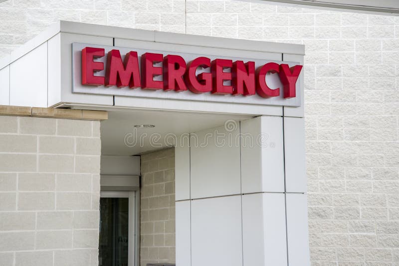 A red hospital emergency sign over the hosiptal emergency entrance. A red hospital emergency sign over the hosiptal emergency entrance