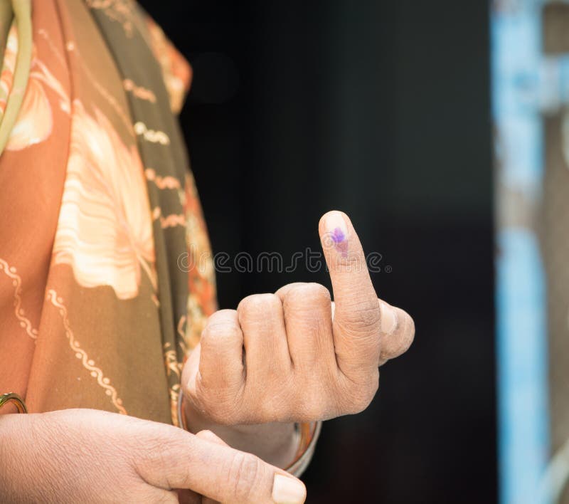 Segno di voto di rappresentazione della mano di una donna indiana dopo la votazione del voto immagini stock Segno di voto di rappresentazione della mano di una donna indiana dopo la votazione del voto immagini stock