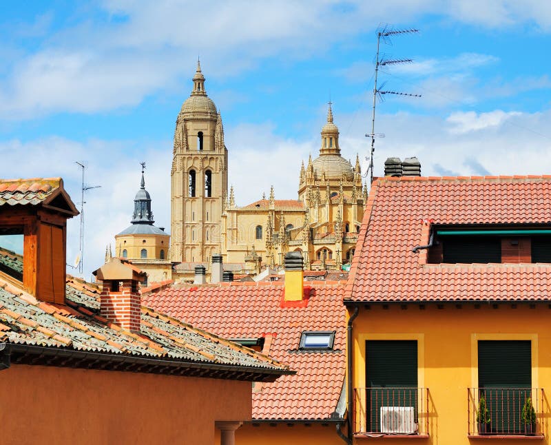 The cathedral of Segovia towering over the houses in the medieval city in Spain. The cathedral of Segovia towering over the houses in the medieval city in Spain.