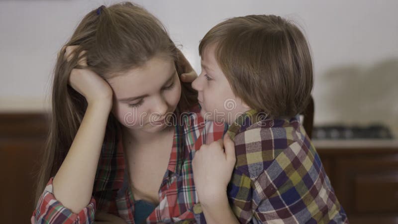 Segreto di sussurro del bambino piccolo adorabile alto vicino del ritratto alla ragazza della sorella più anziana Famiglia amiche