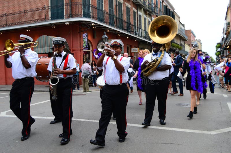 A second line marches through the streets of the French Quarter in New Orleans. A second line marches through the streets of the French Quarter in New Orleans