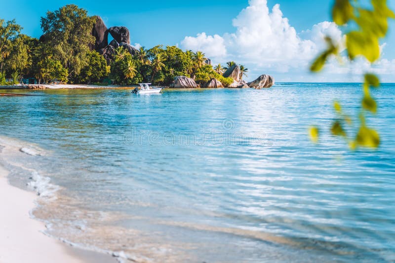 Seychelles. La Digue island famous Anse Source d&#x27;Argent beach. Pleasure tourist vacation boat in ocean shallow lagoon. Seychelles. La Digue island famous Anse Source d&#x27;Argent beach. Pleasure tourist vacation boat in ocean shallow lagoon.