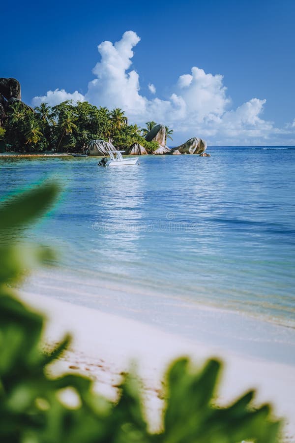 Seychelles. La Digue island famous Anse Source d&#x27;Argent beach. Pleasure tourist vacation boat in ocean shallow lagoon. Seychelles. La Digue island famous Anse Source d&#x27;Argent beach. Pleasure tourist vacation boat in ocean shallow lagoon.