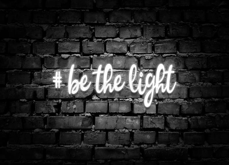 Be the light. Shining hashtag on gray brick wall background. Positive message. Be the light. Shining hashtag on gray brick wall background. Positive message