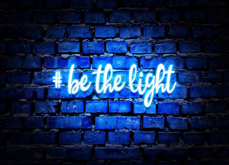 Be the light. Shining neon hashtag on blue brick wall background. Positive message. Be the light. Shining neon hashtag on blue brick wall background. Positive message