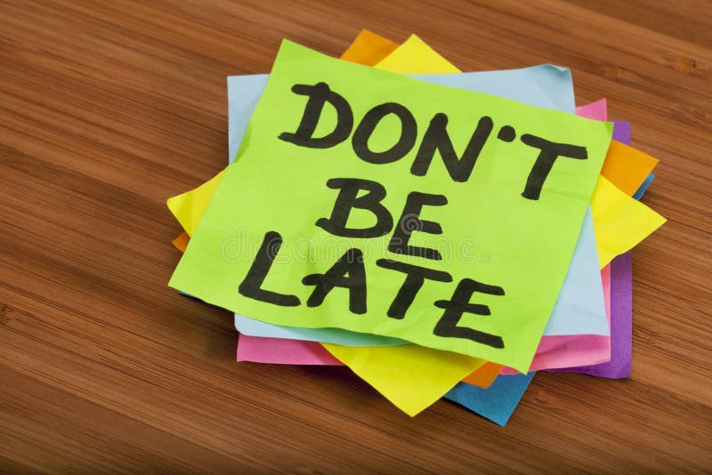 Don't be late reminder - stack of color sticky notes against wooden (bamboo) background. Don't be late reminder - stack of color sticky notes against wooden (bamboo) background