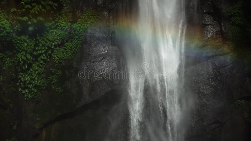 Sekumpul Waterfall in Bali with a rainbow, Indonesia. Slowmotion